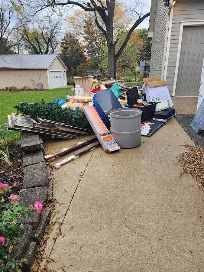 Dumpster being loaded with debris for Estate Cleanout Dumpster Rental in Batesburg-Leesville